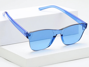 a pair of blue sunglasses sitting on top of a white box