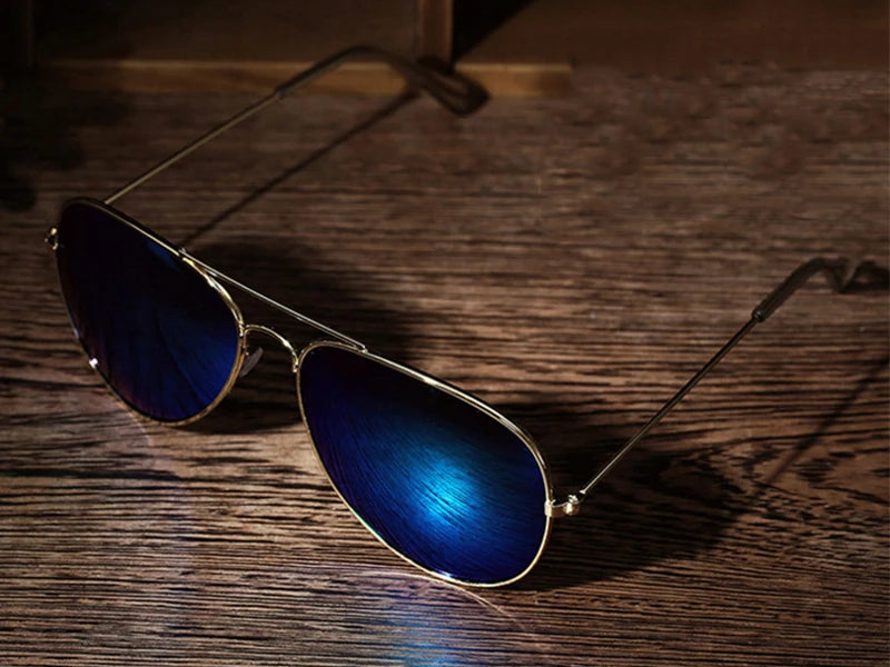 a pair of sunglasses sitting on top of a wooden table